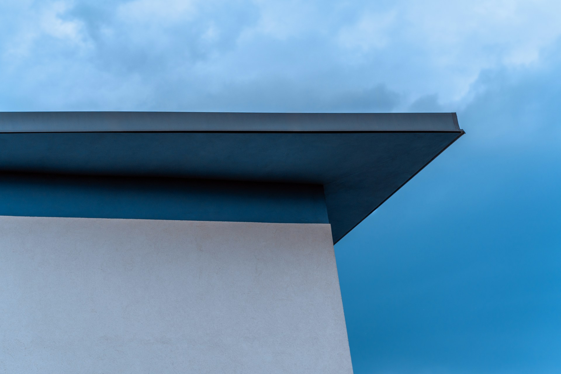 Flat membrane roof with HVAC unit and parapet wall