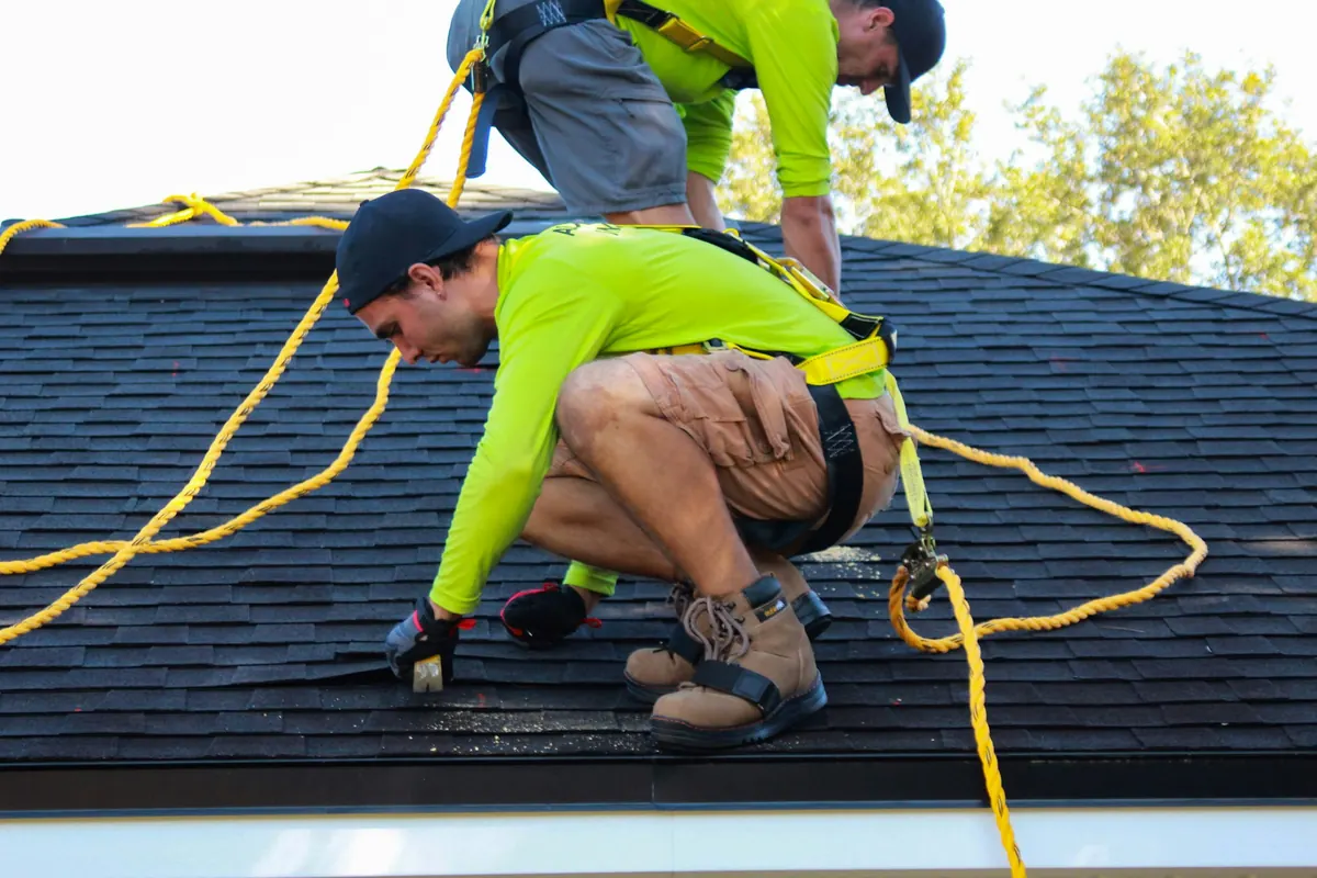Yarco Roofing emergency response crew tarping a storm-damaged roof in North Alabama